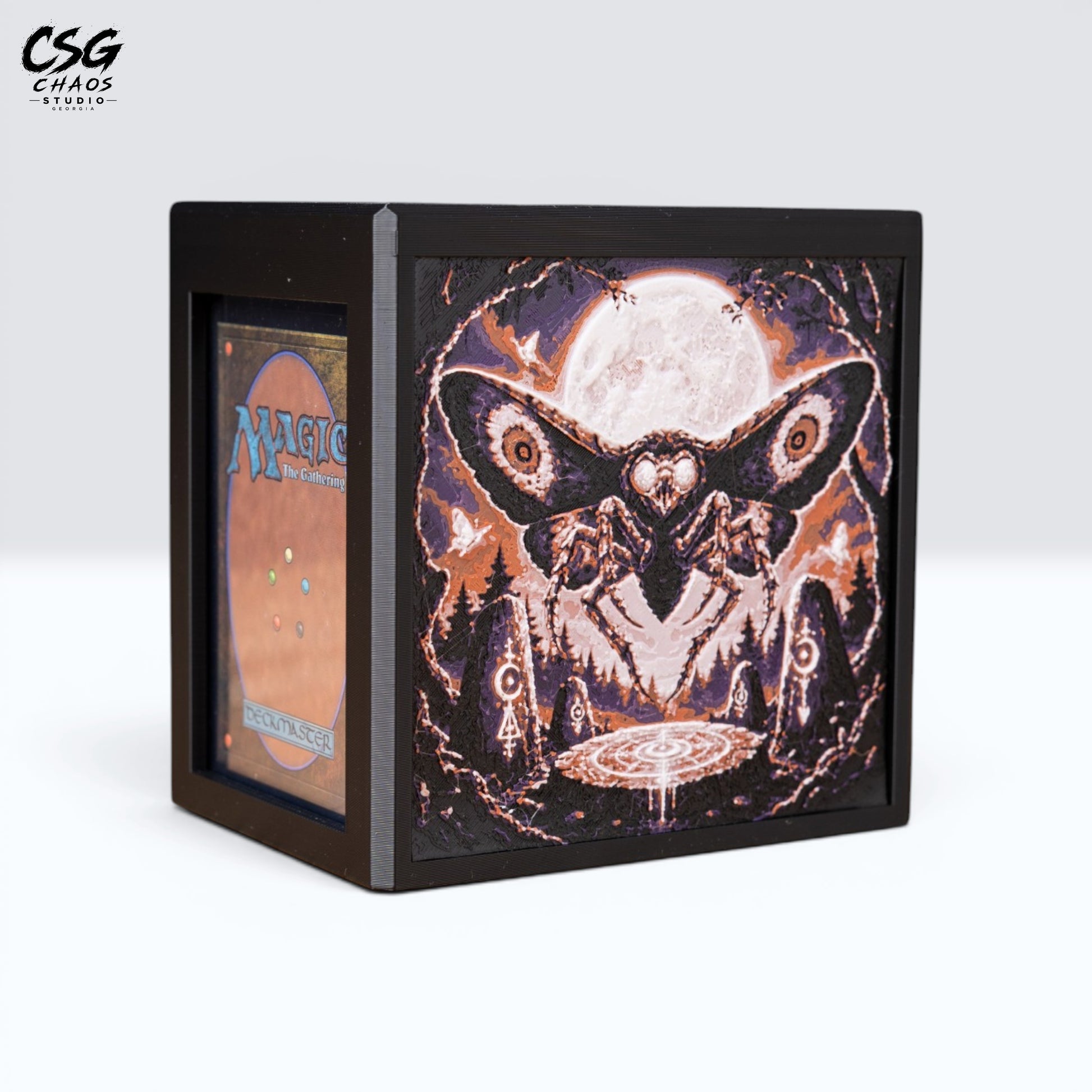 MTG Commander deck box with lid open and a card in the front display window, moth-and-moon panel — Chaos Studio Georgia
