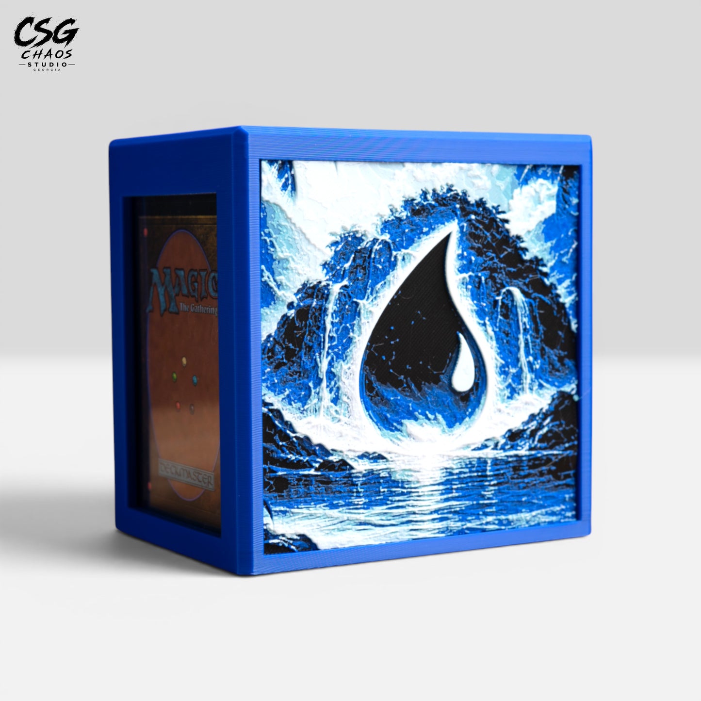 MTG Commander deck box with lid slid open and a card in the front display window, blue waterfall art — Chaos Studio Georgia