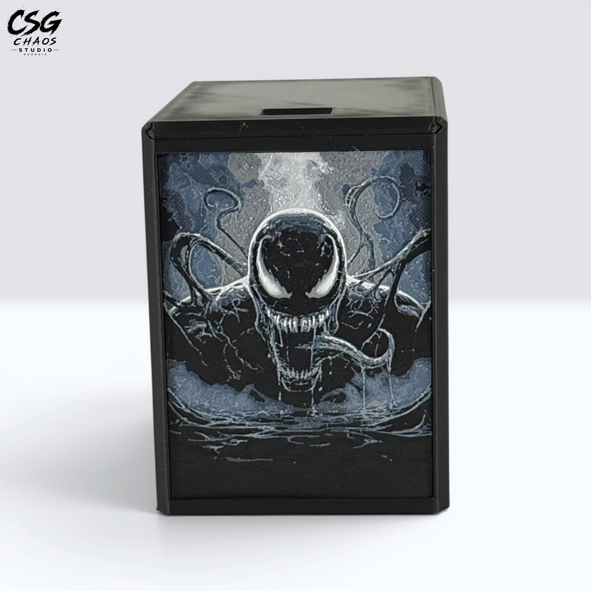 MTG Commander Deck Box PRISM Series, close-up front view of snarling symbiote antihero face on white background — Chaos Studio Georgia