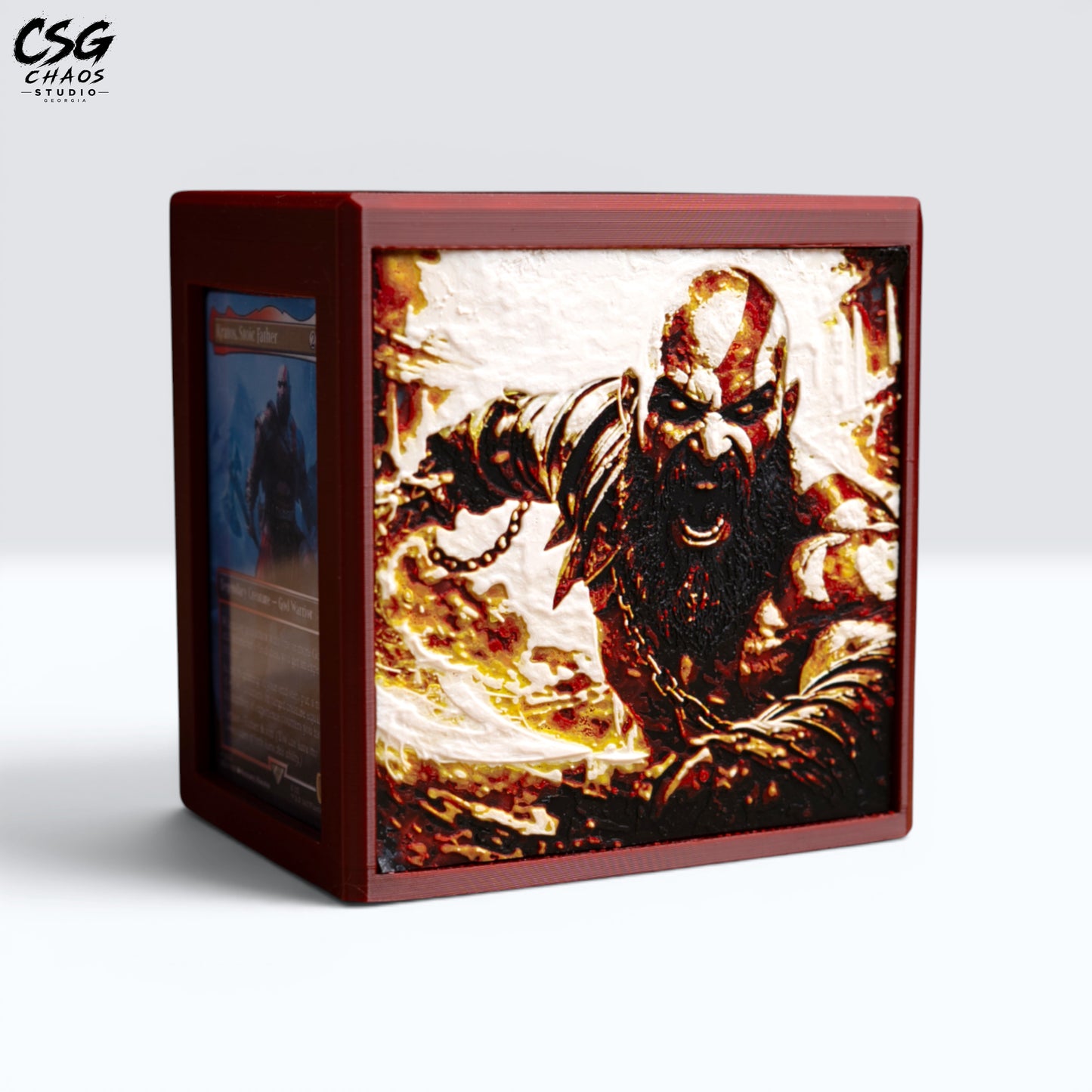 MTG Commander Deck Box PRISM Series, close angle detail of battle god face panel art with card visible — Chaos Studio Georgia