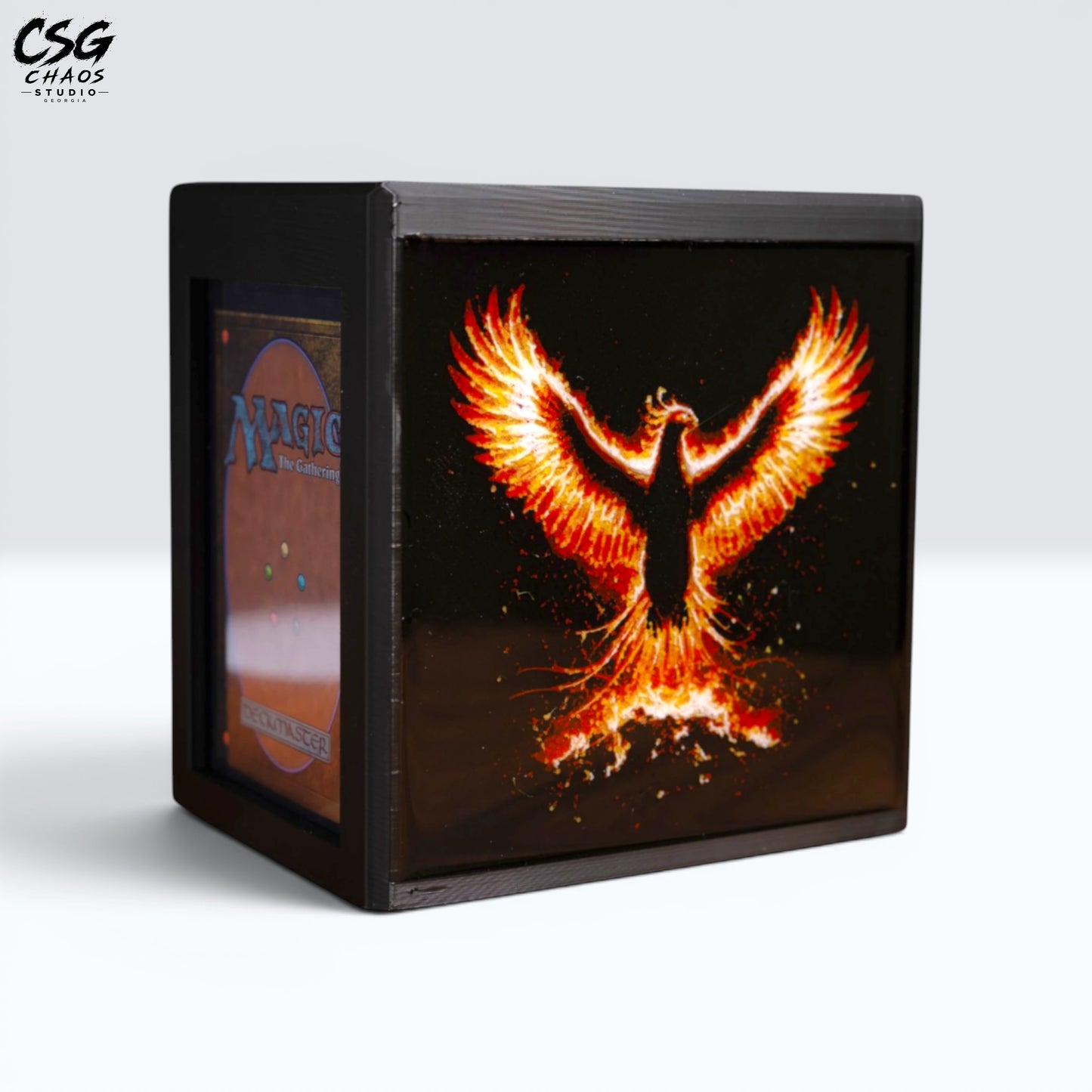 MTG Commander Deck Box PRISM Series, angled front view with lid open revealing card slot and phoenix art — Chaos Studio Georgia