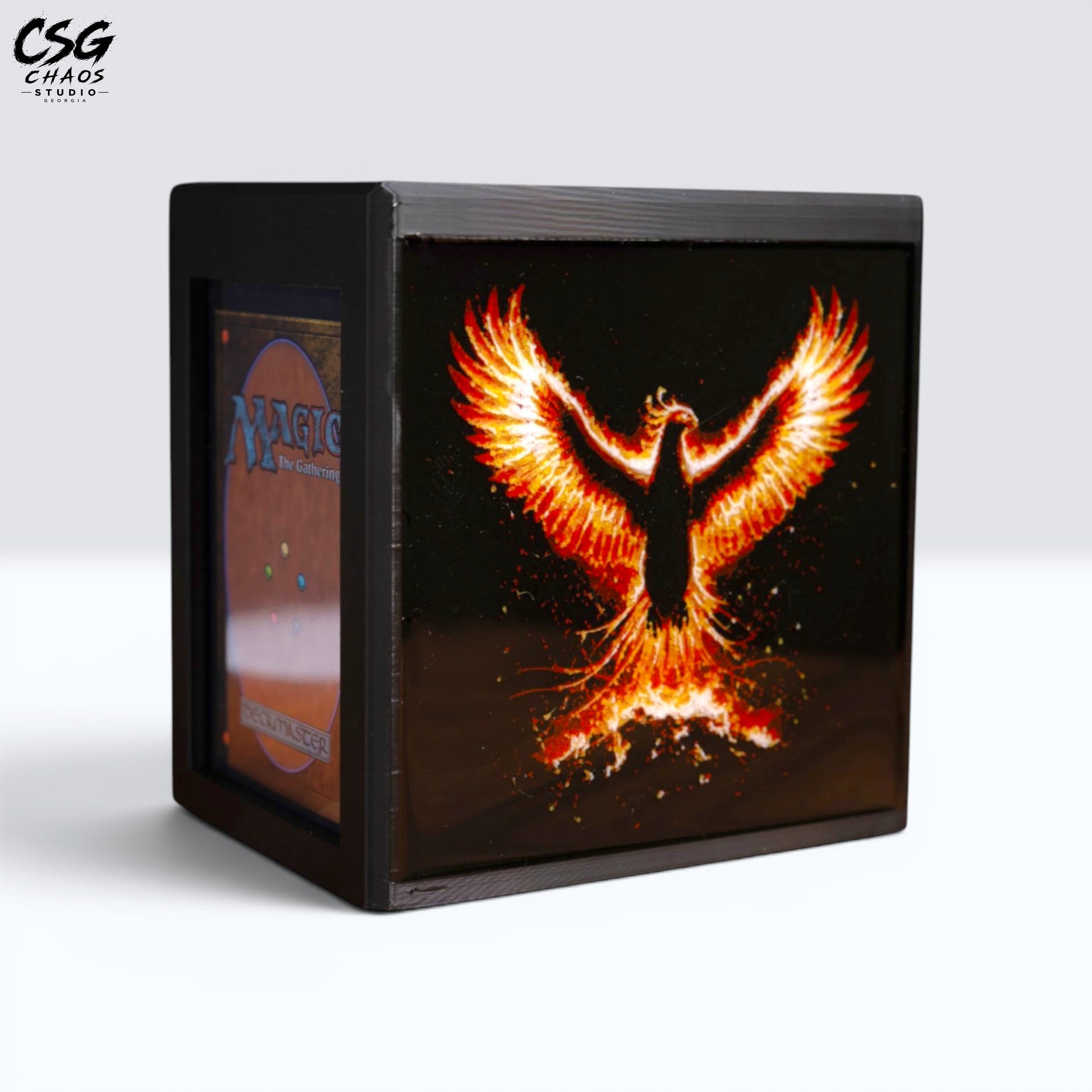 MTG Commander Deck Box PRISM Series, angled front view with lid open revealing card slot and phoenix art — Chaos Studio Georgia
