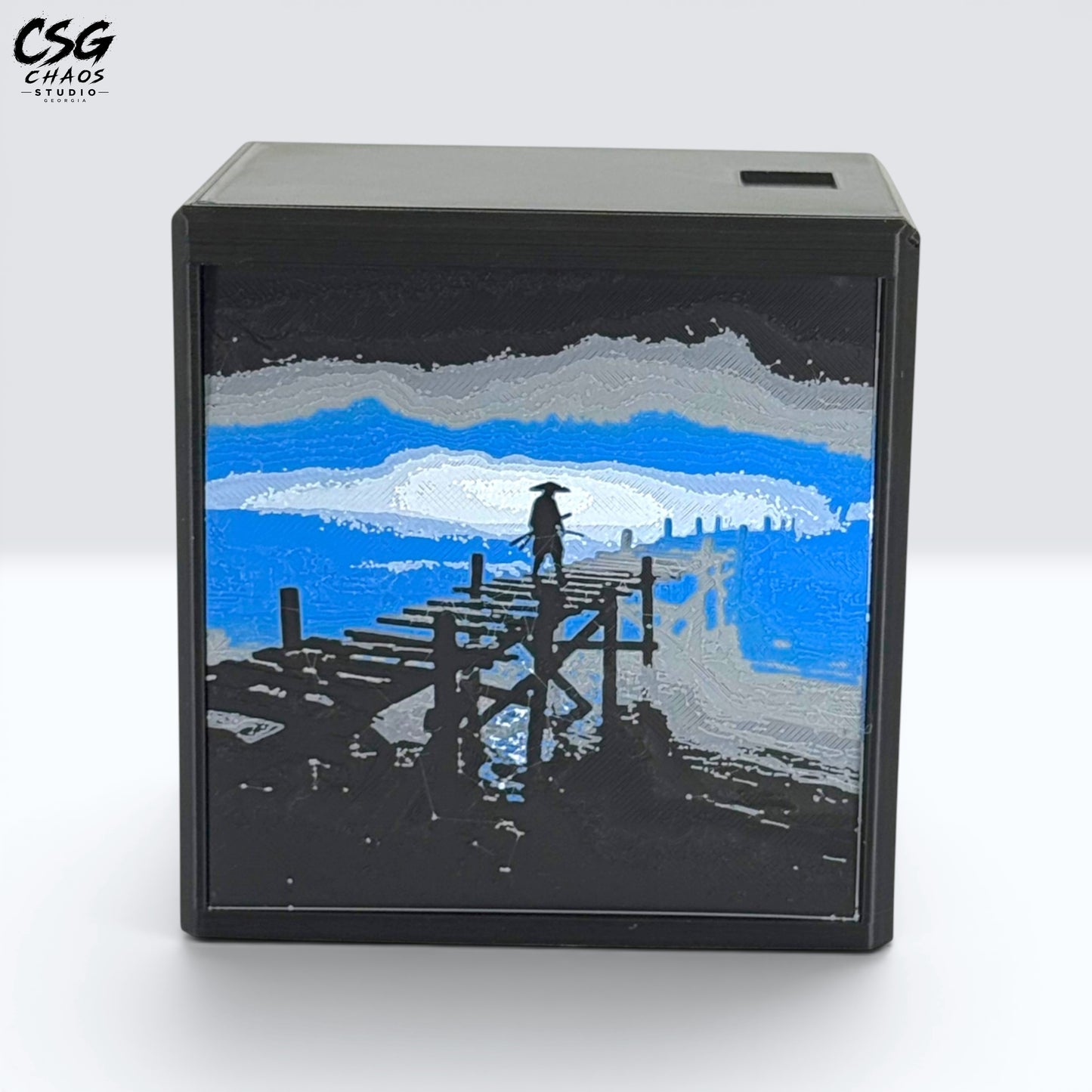 MTG Commander Deck Box PRISM Series, corner view of moonlit pier art on a branded dark backdrop — Chaos Studio Georgia