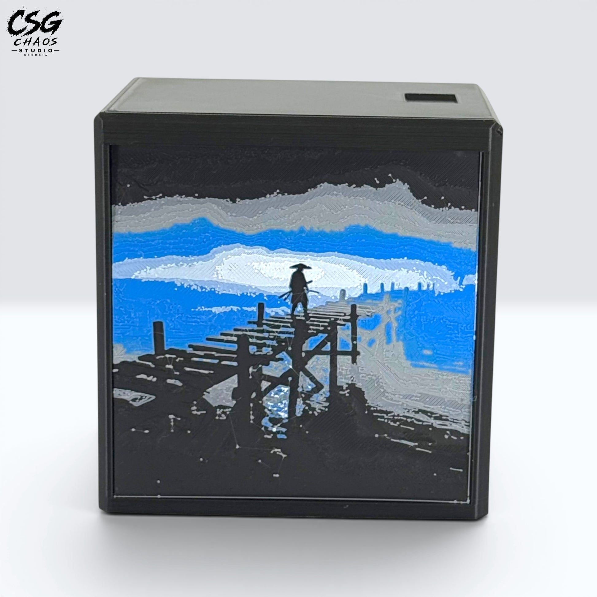MTG Commander Deck Box PRISM Series, corner view of moonlit pier art on a branded dark backdrop — Chaos Studio Georgia