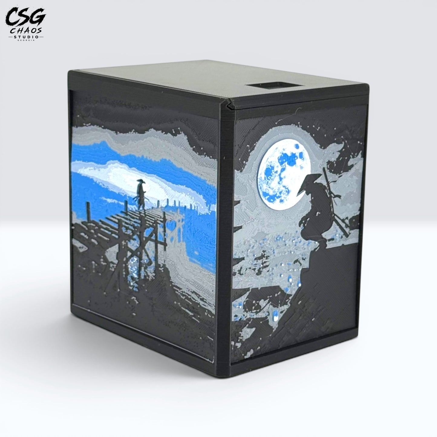 MTG Commander Deck Box PRISM Series, front view of moonlit pier art on a branded dark backdrop — Chaos Studio Georgia