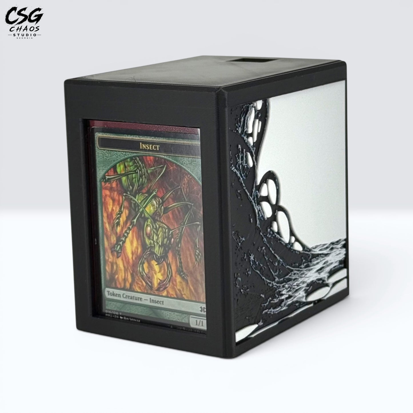 MTG Commander Deck Box PRISM Series, angled view with insect creature card displayed in top loader slot — Chaos Studio Georgia