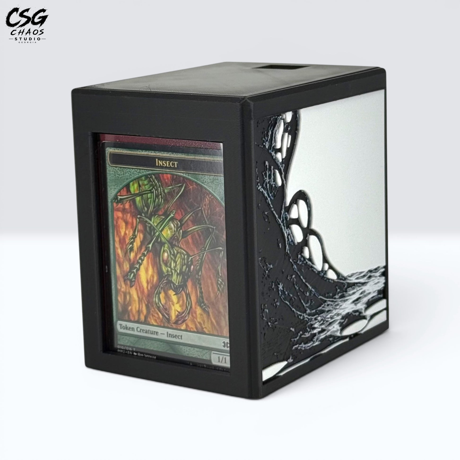 MTG Commander Deck Box PRISM Series, angled view with insect creature card displayed in top loader slot — Chaos Studio Georgia
