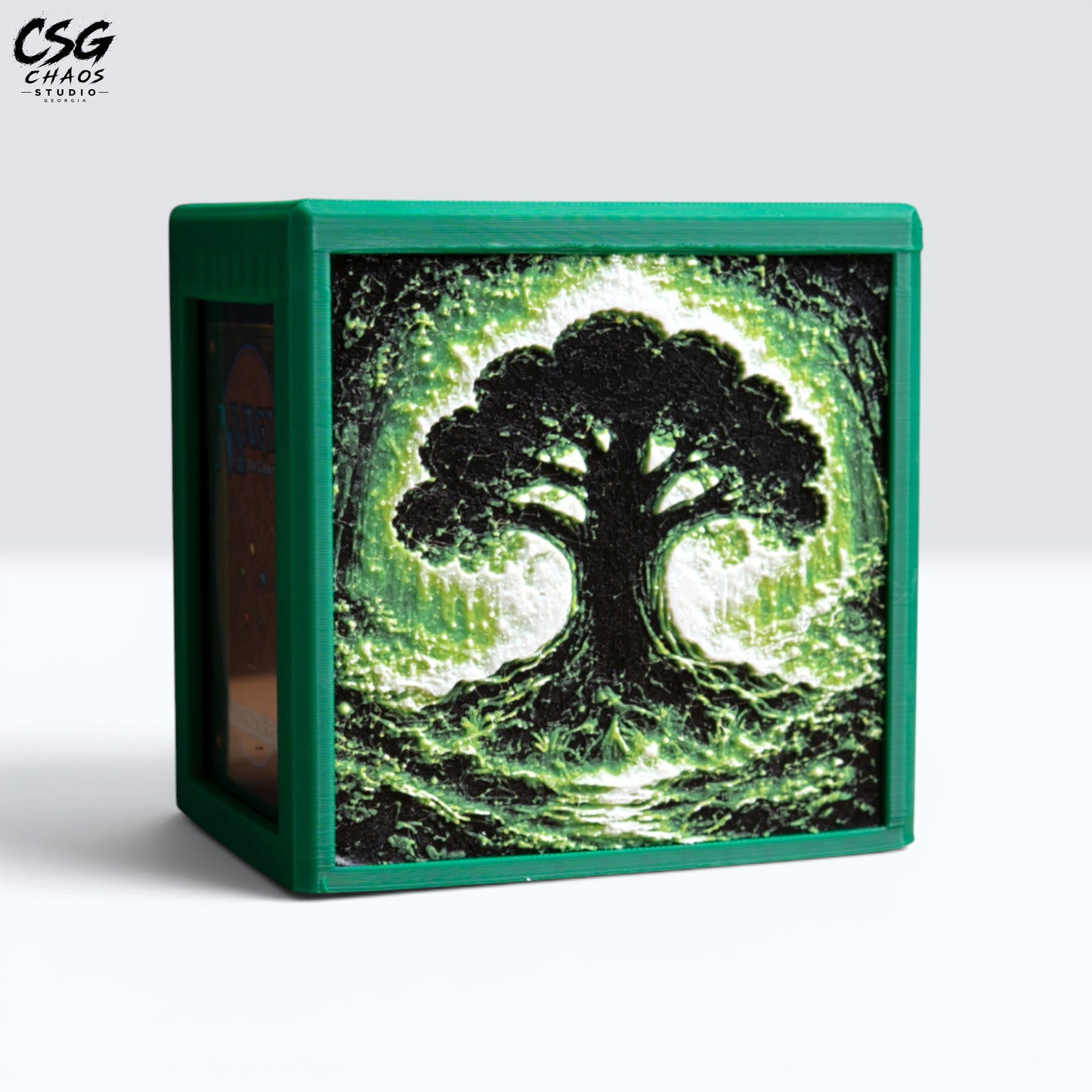 MTG Commander Deck Box PRISM Series, straight-on front view with glowing tree silhouette in green — Chaos Studio Georgia
