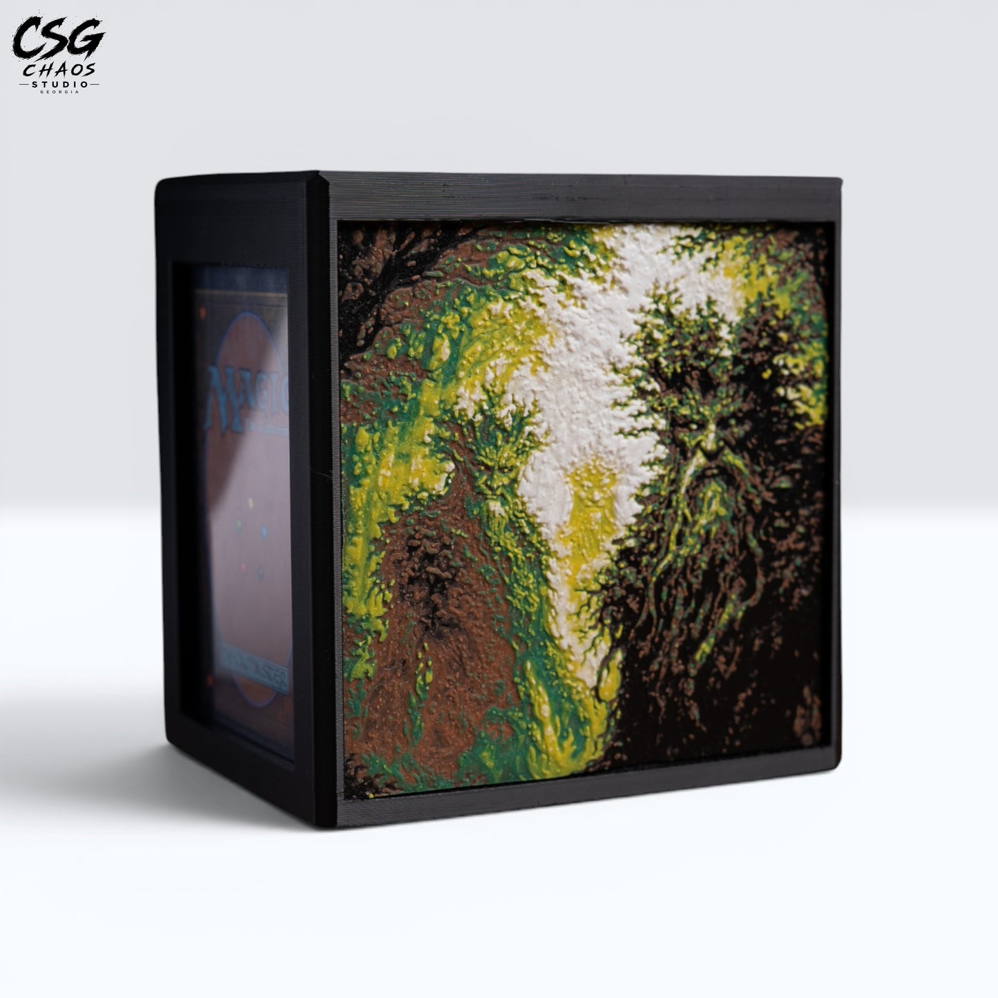 MTG Commander Deck Box PRISM Series, straight-on front view with glowing forest and treefolk figures — Chaos Studio Georgia