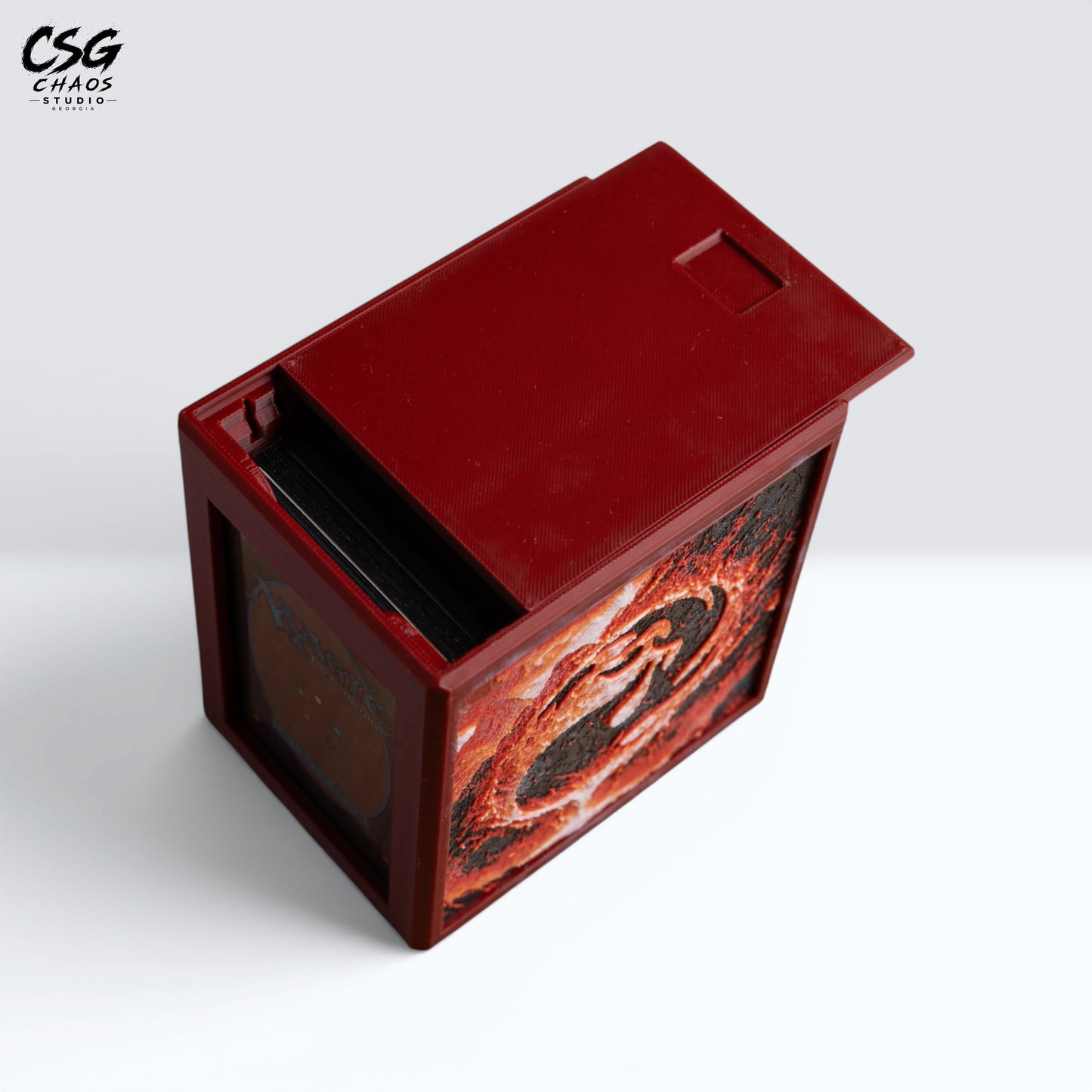 MTG Commander deck box with lid open and a card in the front display window, molten lava panel — Chaos Studio Georgia